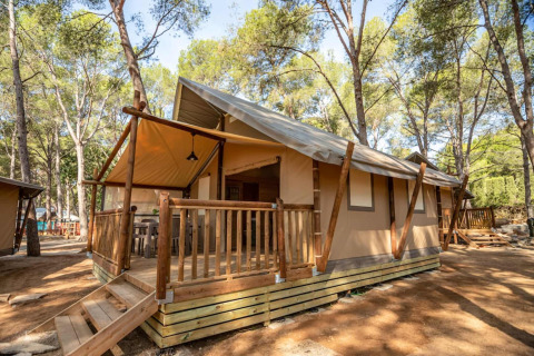 Glamping accommodation at Camping & Resort La Torre del Sol - Safaritenten Costa Dorada, among pine trees.