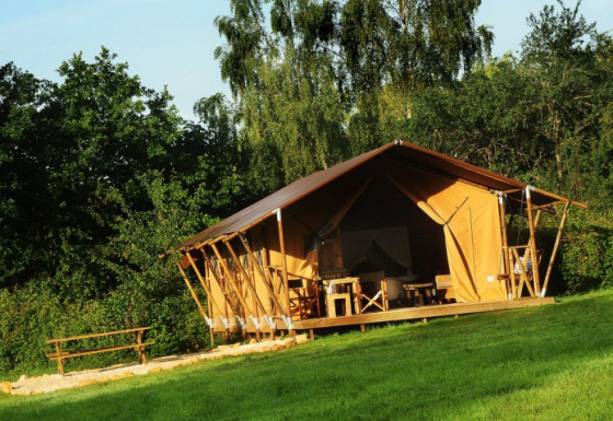 Glampingverblijf Kimaro Farmhouse - Safaritenten Bourgogne, safaritent met terras in een groene omgeving.