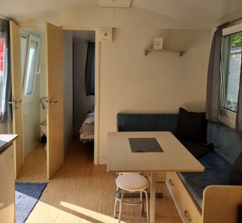 Interior view of Glamping Bad Gastein - Kurcamping Erlengrund featuring a dining table and sofa bench.