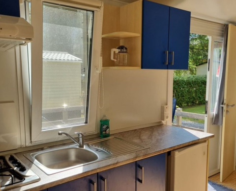 Kitchen area in Glamping Bad Gastein - Kurcamping Erlengrund, featuring a sink, window, and open door.