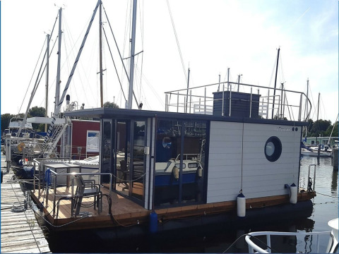 Hausboot Wind & Wellen - Woontboot Sleeswijk-Holstein im Hafen, ideal für komfortables Glamping.