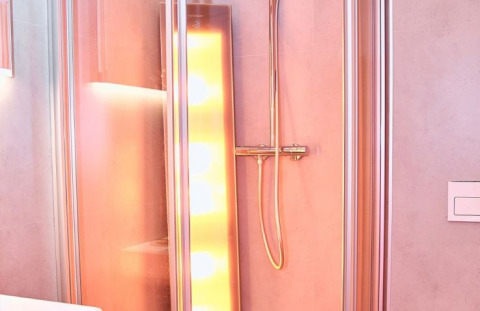 Modern shower with illuminated panel in UplandParcs Sauerland - Wellness Cottage, North Rhine-Westphalia.