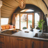 Modern glamping accommodation at Camping De Bovenberg – Lodgetenten Twente with kitchen and lounge area.