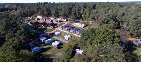 Aerial view of Vakantiepark Havelberge with Ocala Premium glamping caravans in a forested vacation park.