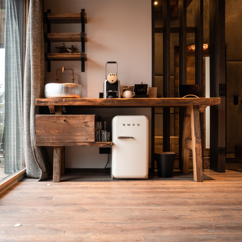 Rustic kitchenette with SMEG mini fridge and coffee maker in the glamping lodge at Gassner Boomhut Austria.