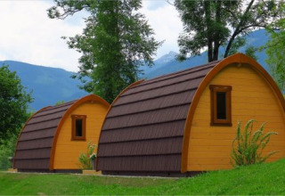 Cozy glamping pods at Camping Putterersee in Austria, set among green hills and mountain scenery.