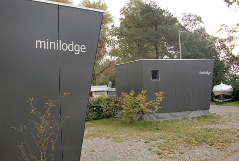 Modern mini lodges at Campingpark Gohren, great for glamping in Baden-Württemberg, surrounded by greenery.