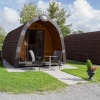 Glamping accommodation at Nordsee Camp-Norddeich - Pods Oost-Friesland with bicycles and outdoor seating.