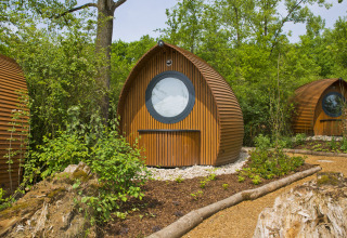 Hébergement glamping au Biosphère Bliesgau, cabanes rondes en bois nichées dans une nature verdoyante.