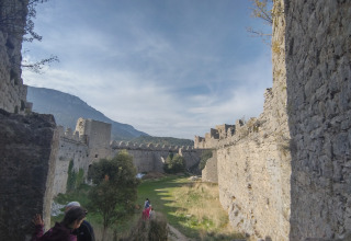 Des personnes explorent les murs d’un château à Camping des Randonneurs - Yurts Occitanië.