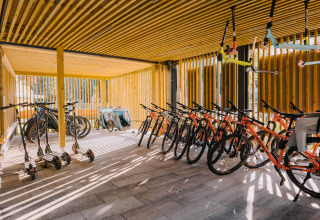 Bike and scooter storage area at River Camping Bled - Lodges Slovenië, a modern glamping accommodation.