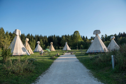 Glamping tipis at Hofgut Hopfenburg, Baden-Württemberg, set in a scenic green landscape and forest.