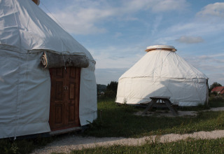 Glamping at Hofgut Hopfenburg, Baden-Württemberg, featuring traditional white yurts and tipi tents.