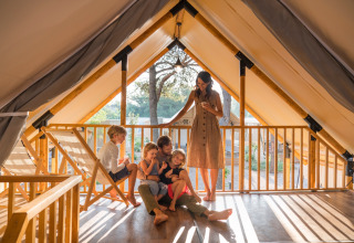 Family relaxing together in a glamping tent at Falkenstein Premium Camping Zadar, Mobile Homes in Dalmatia, Croatia.