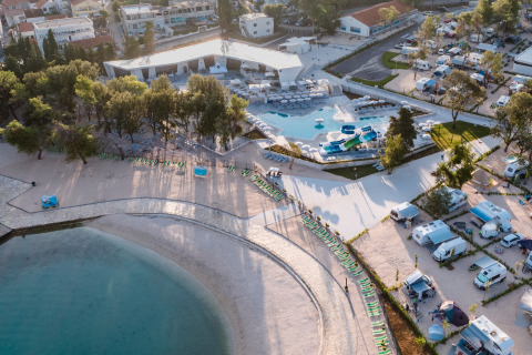 Aerial view of Falkenstein Premium Camping Zadar with mobile homes, pool, and beach in sunny Dalmatia, Croatia.