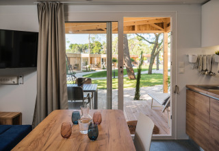 Vista interna di una casa mobile al Falkenstein Premium Camping Zadar con accesso su veranda e spazio verde.