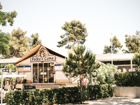 Entrance to Falky's Camp at Falkenstein Premium Camping Zadar, surrounded by green trees and bushes.