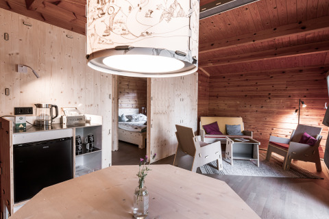 Interior of a modern wooden cabin with cozy living area and bedroom at Destinature Dorf Südeifel.