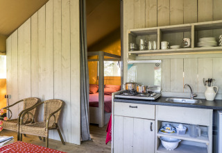 Glampingindkvartering ved Voedselbron Graauw - Safaritenten Zeeland med køkken og soveområde.