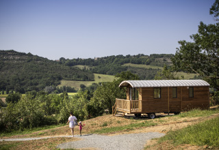 Glamping accommodation at Camping Huttopia Pays de Cordes Sur Ciel in Occitanie, with rolling hill views.
