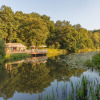 Glamping accommodation Camping Huttopia De Roos by the Vecht River in Overijssel with lush forest views.