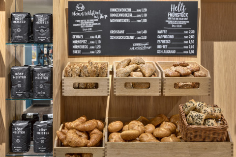 Assorted fresh breads and coffee selection displayed at Natürlich Hell Camping & Aparthotel - Tuin Lodges Tirol.