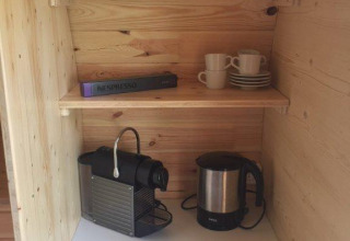 Camping Hegne luxury pod Bodensee: wood shelves, Nespresso machine, kettle and cups for glamping.