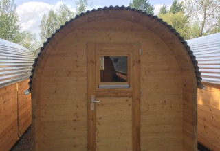 Wooden glamping pod accommodation at Camping Hegne by Lake Constance, with nature and other pods.