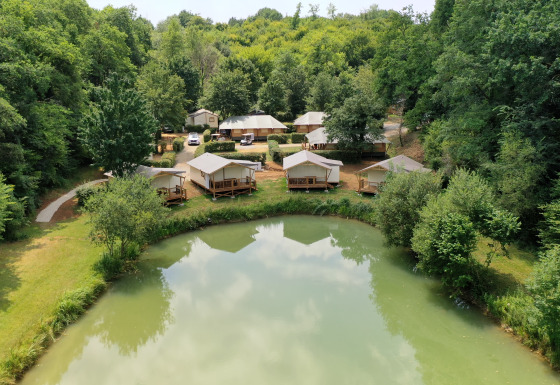 Glamping junto al estanque en Les Truffières de Dordogne – La Bouquerie – Safaritenten, Nouvelle-Aquitaine, rodeado de bosque.