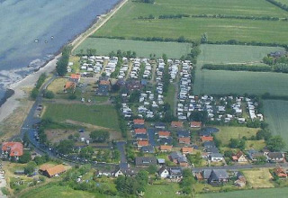 Aerial view of Camping Wackerballig with chalets and campsites by the coast in Schleswig-Holstein, Germany.