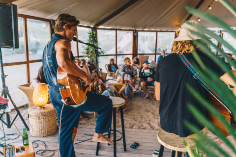 Serata musicale acustica al Surfana Family Camp Bloemendaal Glamping con ospiti rilassati e musica dal vivo.