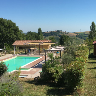 Outdoor pool and garden view at Agriturismo Camping Le Marche & Villa Ti Amo - Glamping Le Marche, Italy.