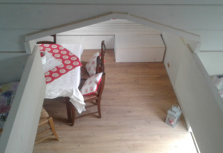 Interior view of glamping at Agriturismo Camping Le Marche & Villa Ti Amo featuring cozy dining area and bed.