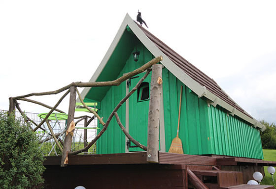 Green glamping cabin with rustic wooden porch and broom, Camping Naumburg - Glamping Hessen countryside stay