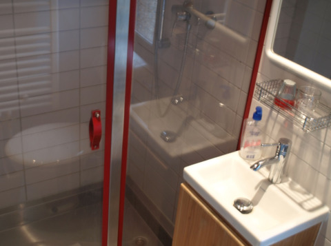 Bathroom with shower, sink, and mirror in a chalet at Campingpark Lindelgrund, Rhineland-Palatinate.
