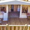 Glamping accommodation with wooden deck, loungers and table at Vacanze col Cuore by Lake Garda.