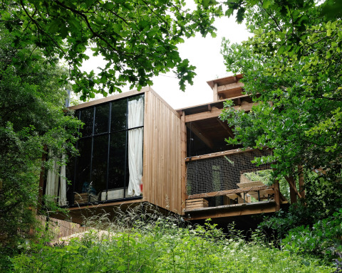 Nutchel - Lodges in the Ardennes, Belgium. Modern wooden glamping accommodation nestled in lush greenery.