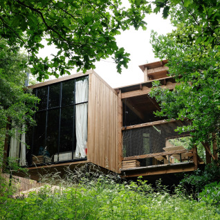 Nutchel - Lodges in the Ardennes, Belgium. Modern wooden glamping accommodation nestled in lush greenery.
