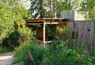 Nutchel lodge accommodation in the Ardennes, Belgium, nestled in lush greenery for a cozy glamping stay.