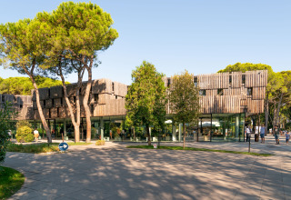 Modern glamping site at Camping Ca Savio - Nordisk Village tents near Venice, surrounded by lush trees.