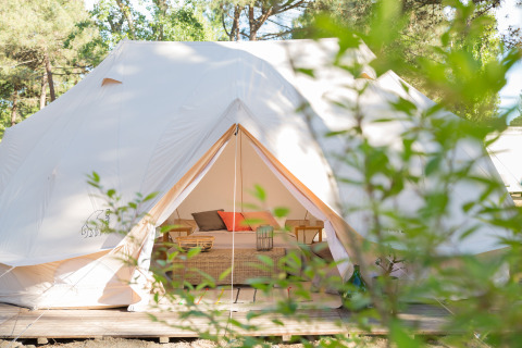Glamping på Camping Ca Savio i Venetië med luksustelt fra Nordisk Village, omgivet af grønne træer.
