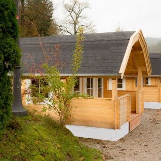 Reihe moderner Glamping-Holzhütten im Campingpark Wiesenbeker Teich in schöner, naturnaher Umgebung.