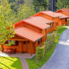 Wooden cabins at Natur-Camping Langenwald - Glampingaccomodaties Baden-Württemberg, nestled by forest.