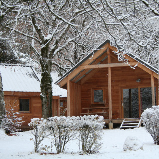 Met sneeuw bedekte chalet bij Huttopia Winter Chalets – Divonne Les Bains, glamping in de Franse Alpen.