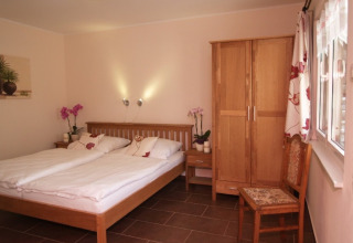 Camera glamping accogliente in Eifelidyll con letto doppio e mobili in legno, Renania-Palatinato.