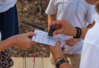 Children’s activity at Trasimeno Glamping Resort with a card being stamped, Vacanze col Cuore holiday.