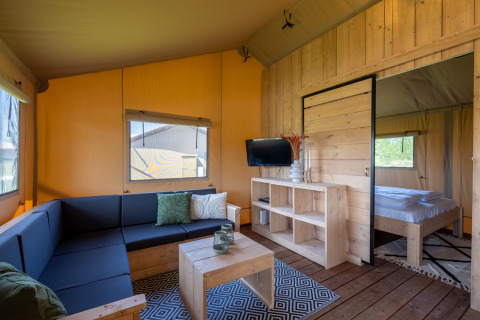 Moderne Glamping-Unterkunft in den Safarilodges von Vakantiepark IJsselhof, mit gemütlichem Holzmobiliar.