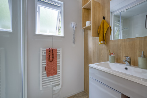Bagno moderno con pannelli in legno e asciugamani a Camping Saint Pabu Plage - Glamping Bretagne.