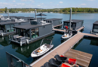 Moderne Hausboote in der Houseboat Marina Mookerplas, Niederlande, mit Stegen und ruhigem Wasser.