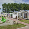 Glamping accommodation at Camping and Holiday Park Wulfener Hals, with paths and colorful ornaments by the Baltic Sea.